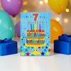 7th Birthday Card - Age 7 Blue Multicoloured Cake and Candles 7.75x5.25