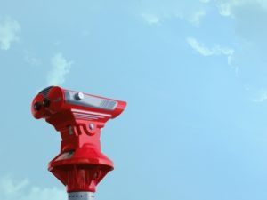 Red telescope against a blue sky