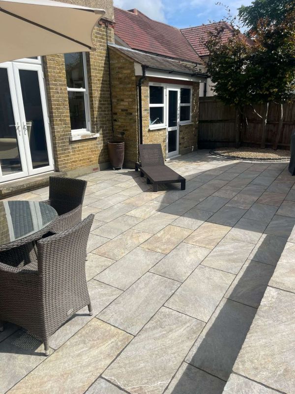 Modern porcelain patio and smart drainage transforms garden