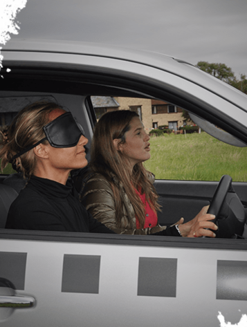 two girls blindfolded driving vehicle