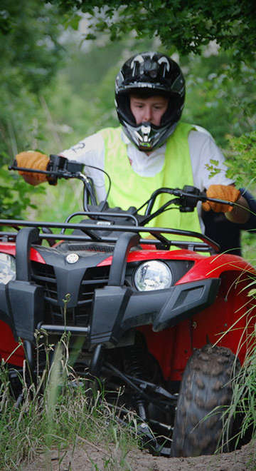 red quad bike going through grass