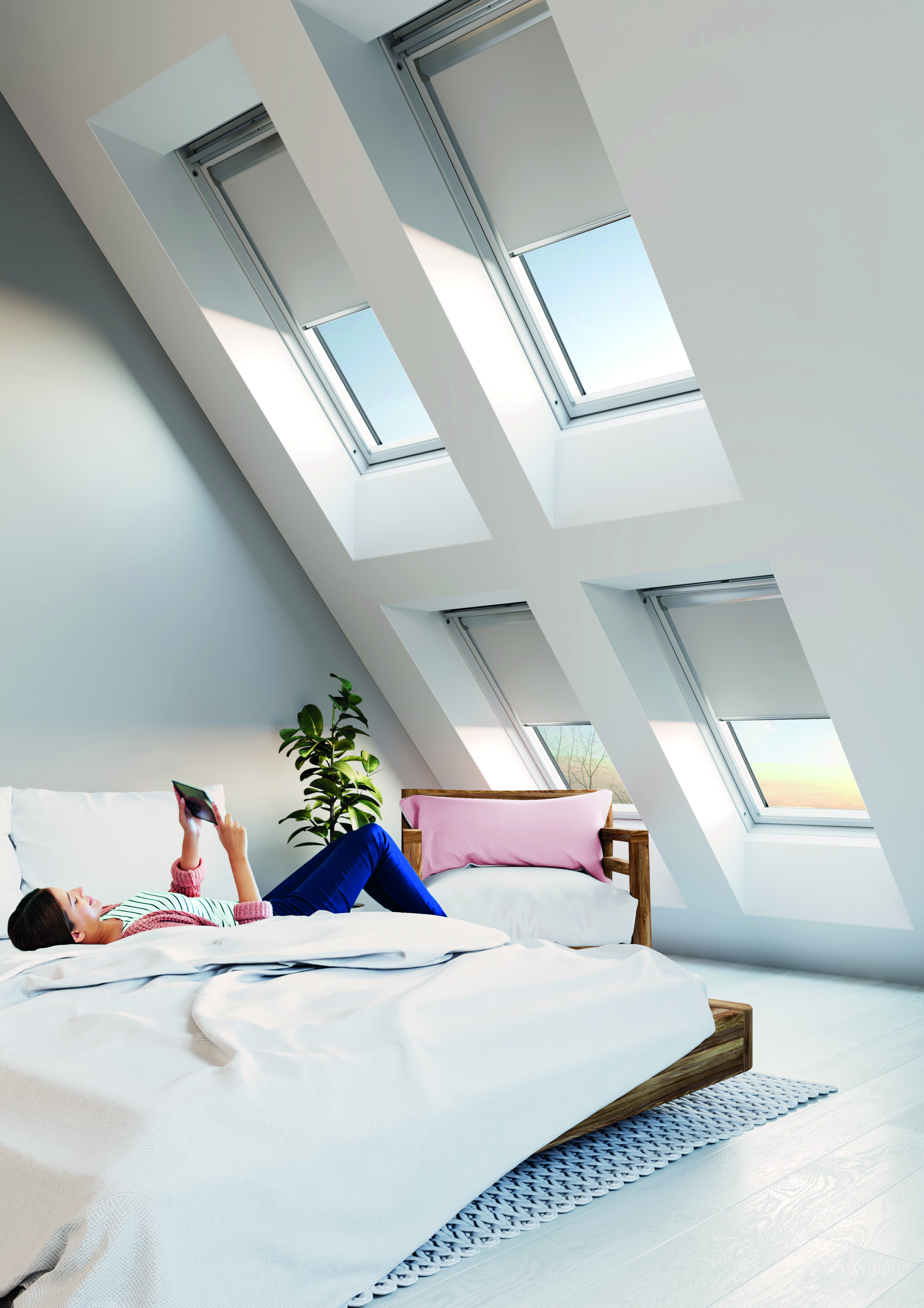 Roof windows in a bedroom to let in more light to the space. 