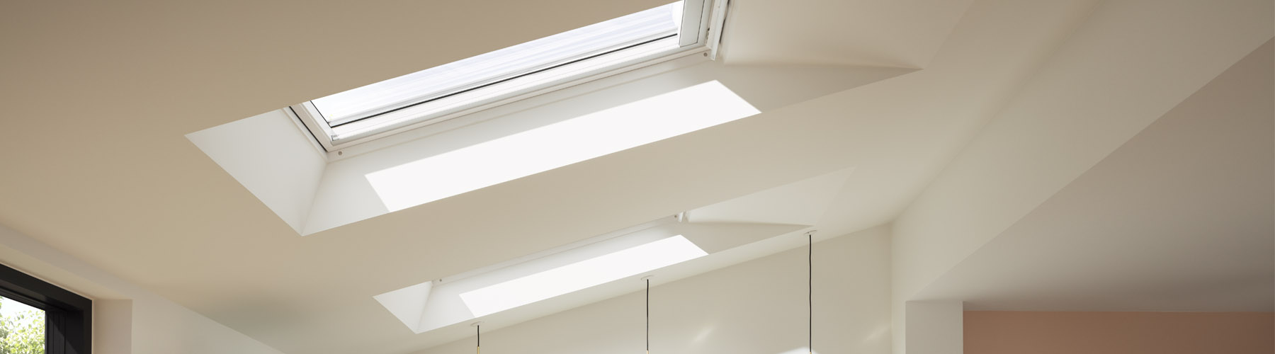 A VELUX blind being used to cover a skylight in a room.