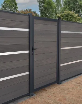 A composite brown gate with composite wall surrounding it. Very modern.