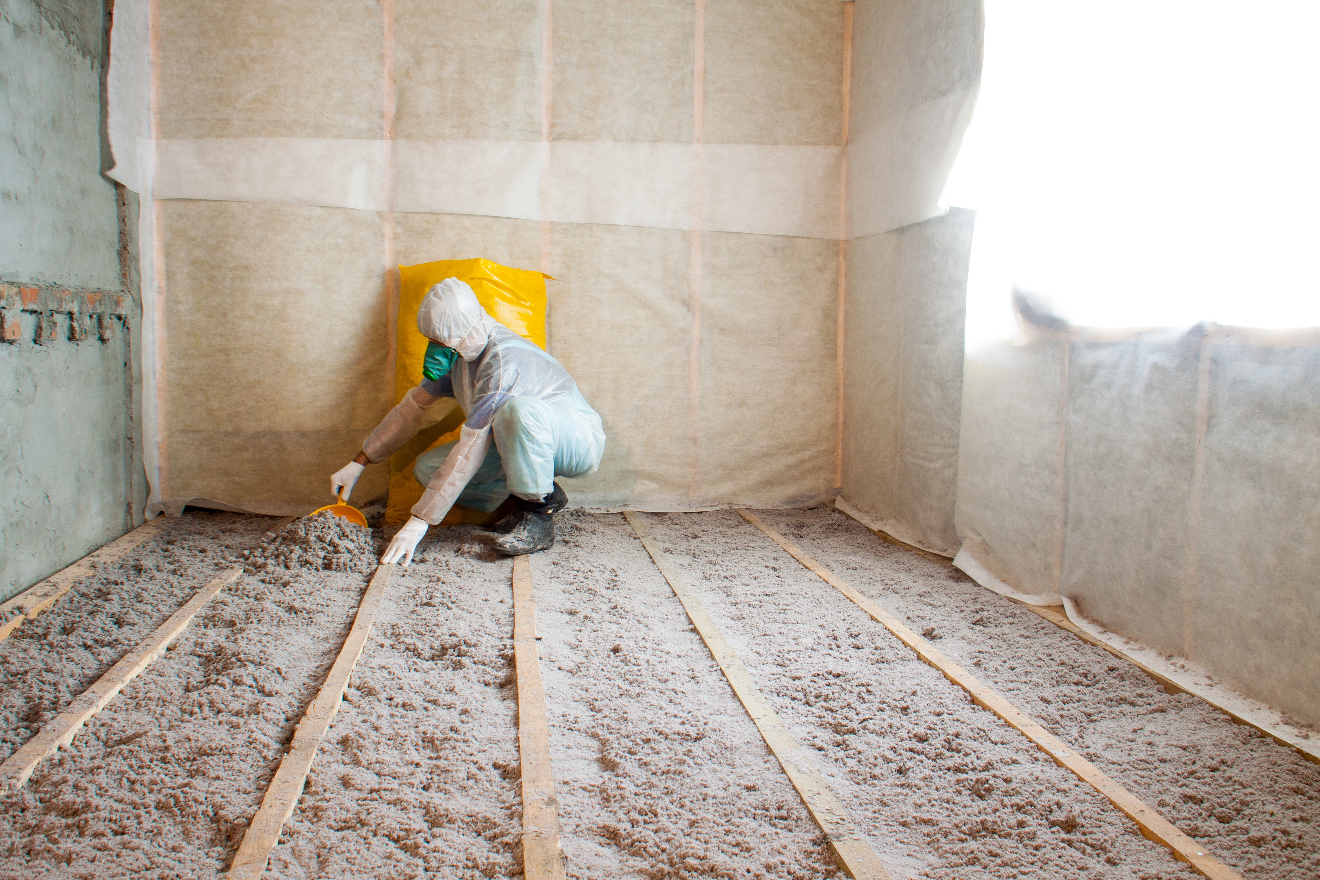 Image of someone fitting floor insulation