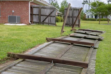 Fence panels that have fallen over in the wind in a person's garden. Make sure to secure your fencing. Fence panels that have fallen over in the wind in a person's garden. Make sure to secure your fencing.