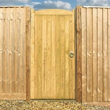 an image of a wooden gate surrounding by bushes