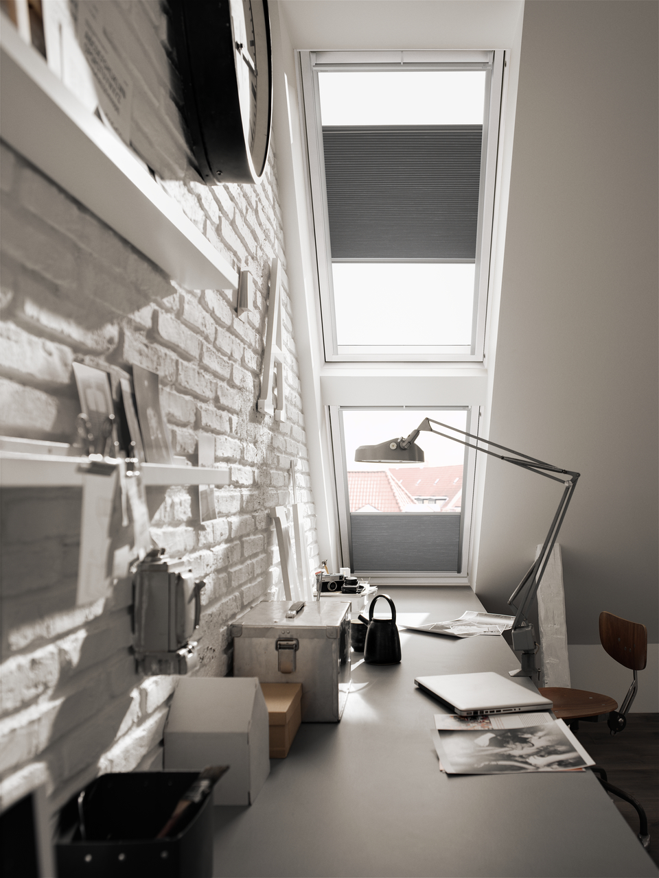 Two bright white windows decorated with VELUX window blinds to bring in a bright light into the room. 
