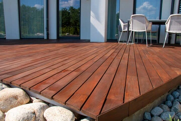 Decking in a sloped garden can instantly create usable seating or dining areas.