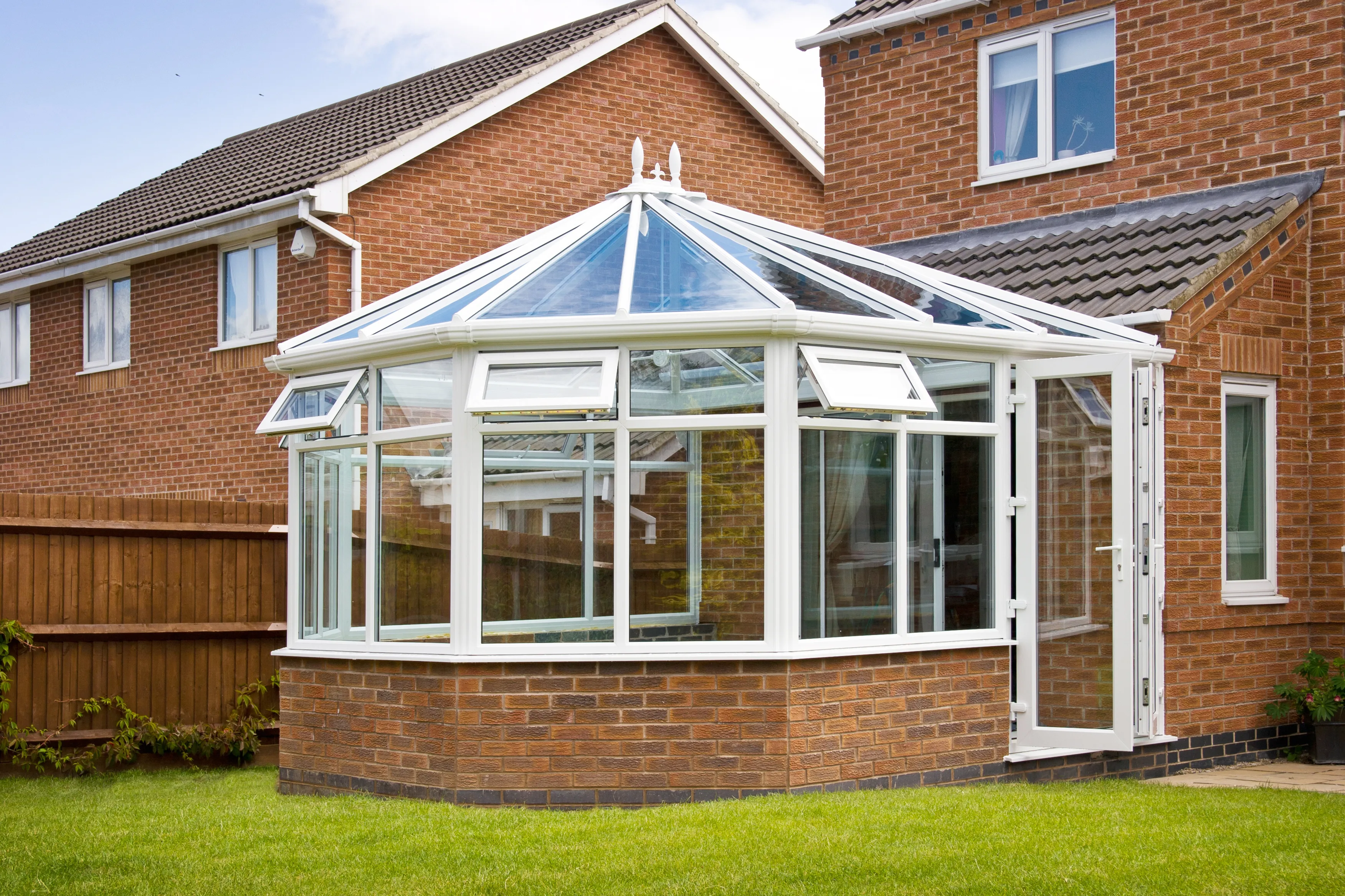 A life-style picture of a conservatory in the back of a home.