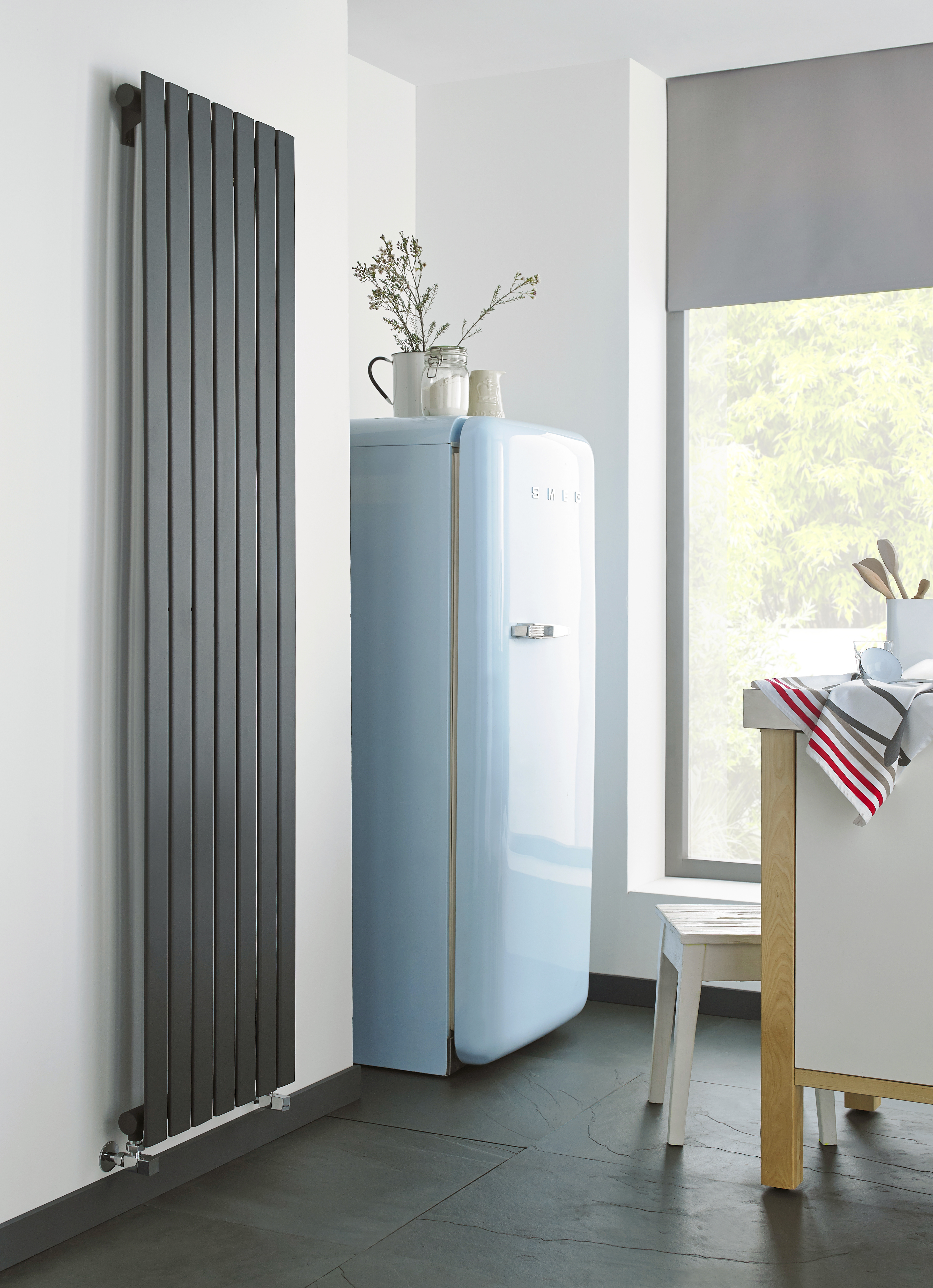 An ultra modern radiator in a kitchen, coloured in black. 