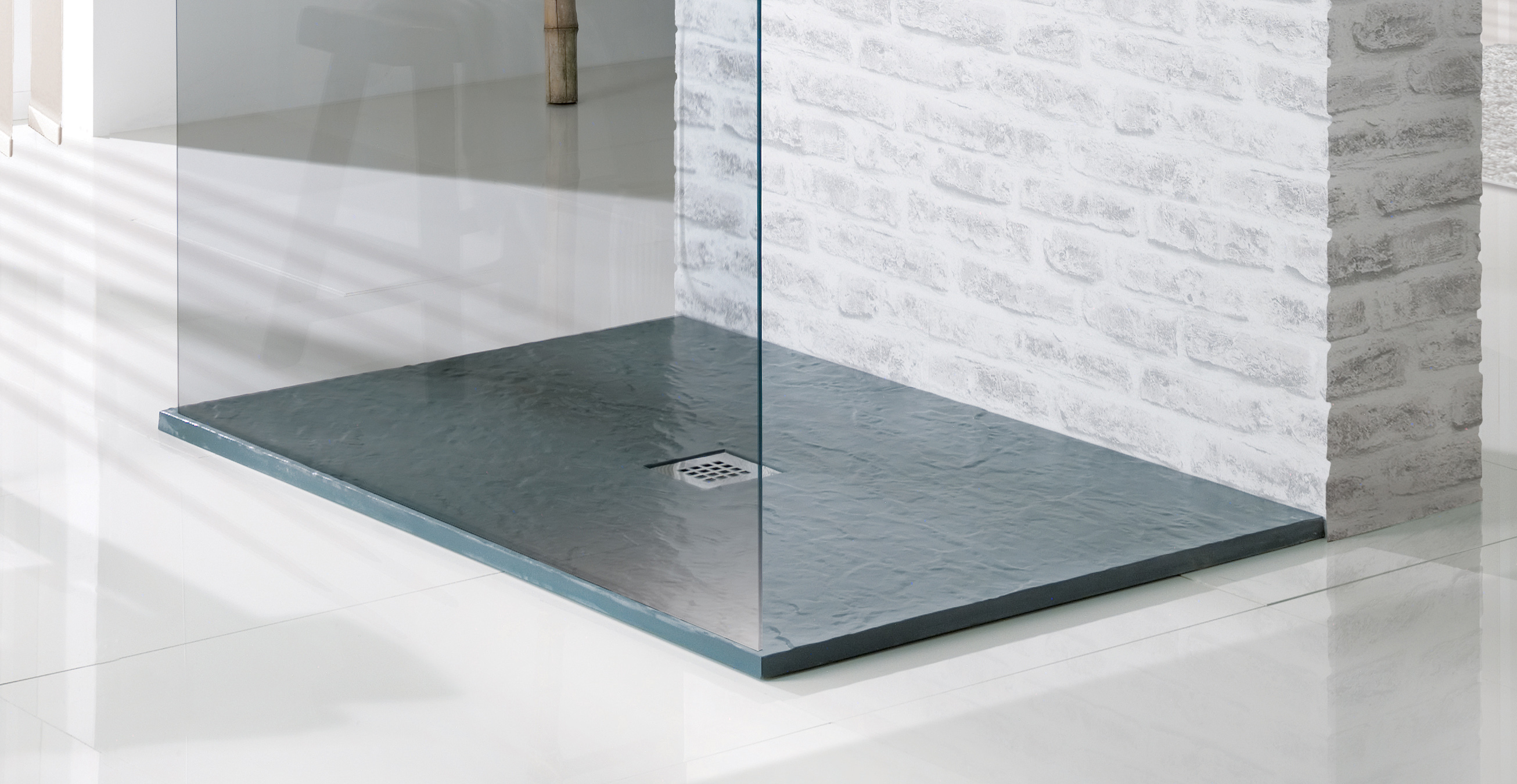 A green geometric shower tray in a modern, upscale bathroom. 