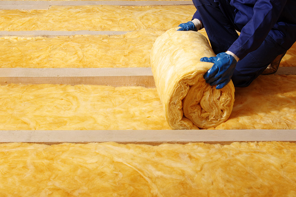 isover wool insulation rolls stacked against wall