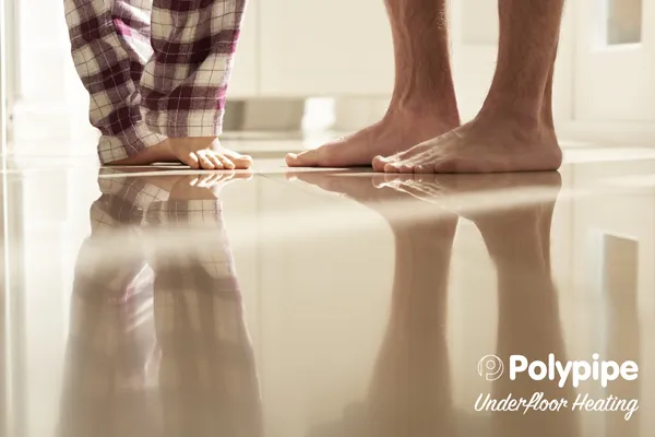 Popyline under-floor heating with peoples feet stood above it. Popyline under-floor heating with peoples feet stood above it.