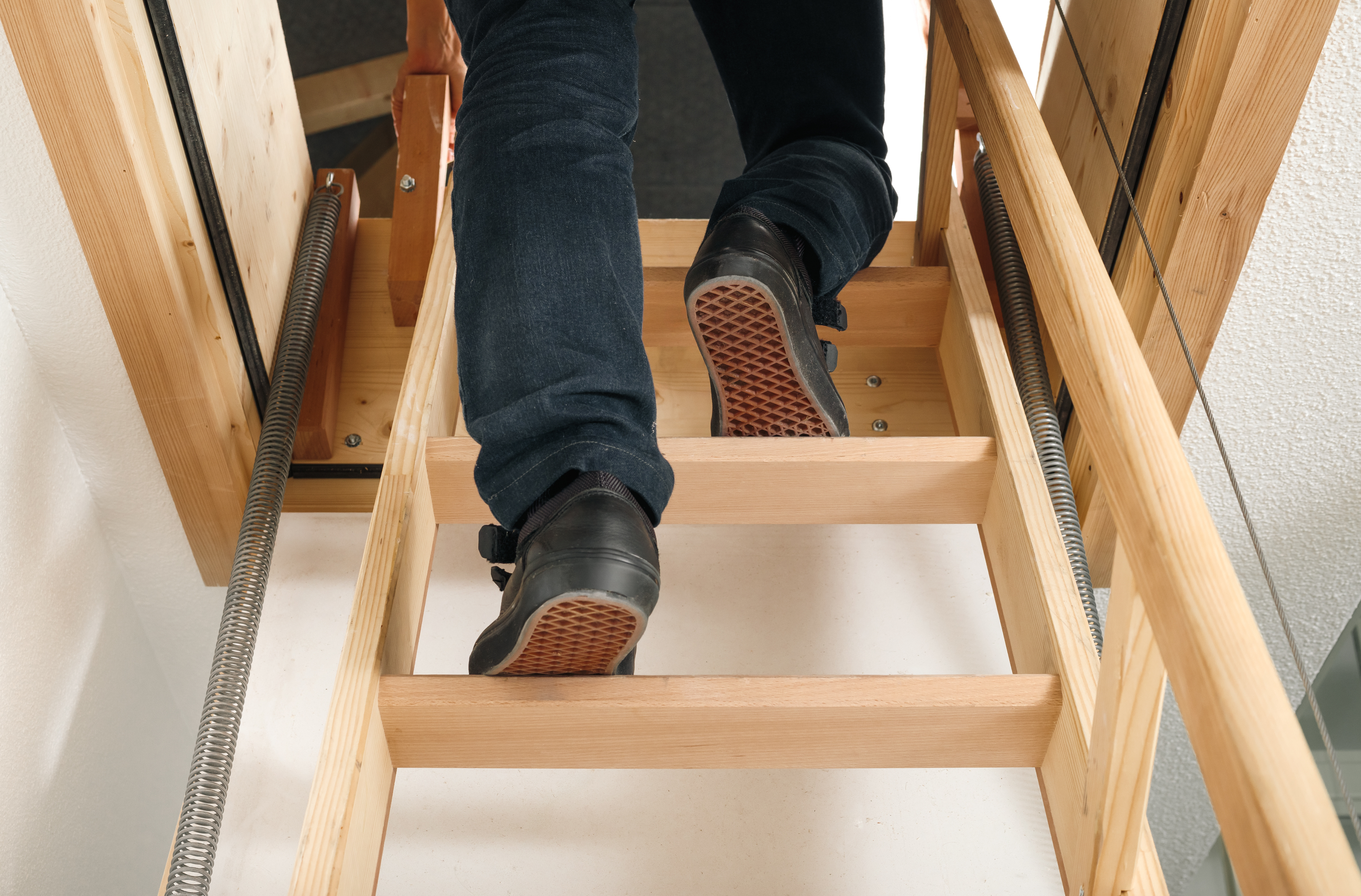 an image of a chrome ladder being used to reach loft