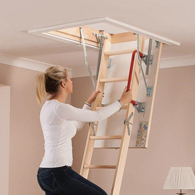 an image of a wooden stairs being used to reach the top of wooden loft