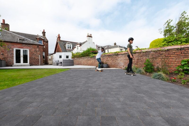 an image of a man in hi-vis applying block paving on top of subbase