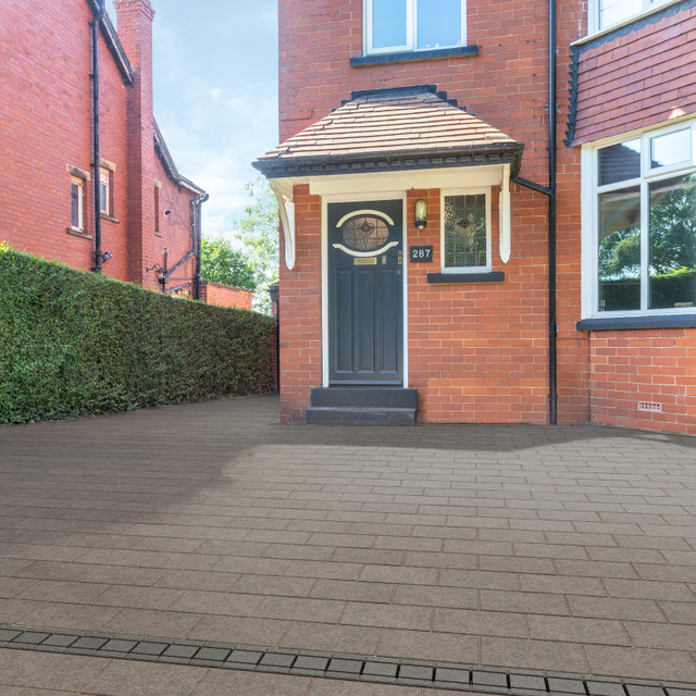 an image of a man aligning block paving against one another