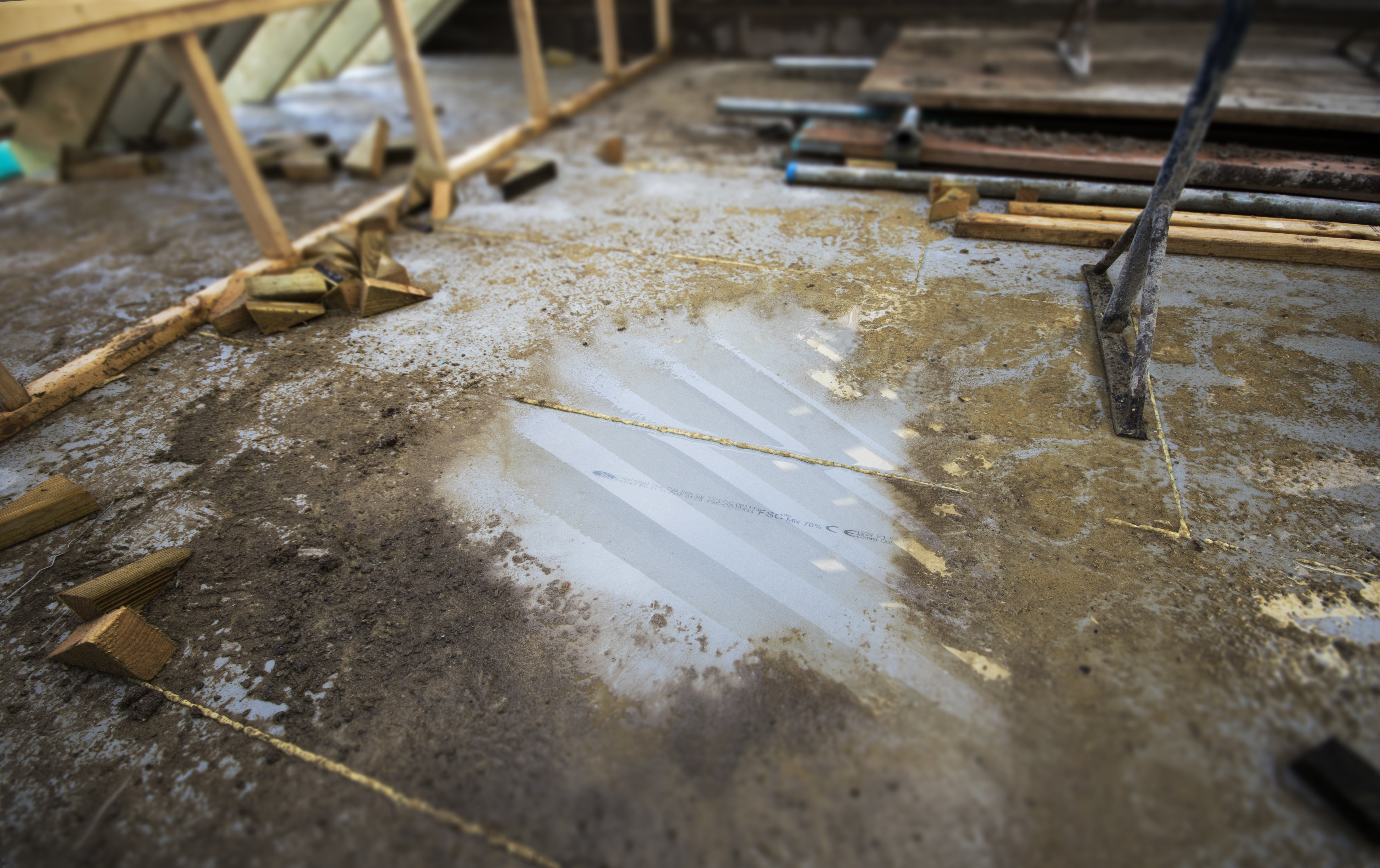 A large loft conversion with builder's work scattered everywhere, most likely a dormer conversion. 