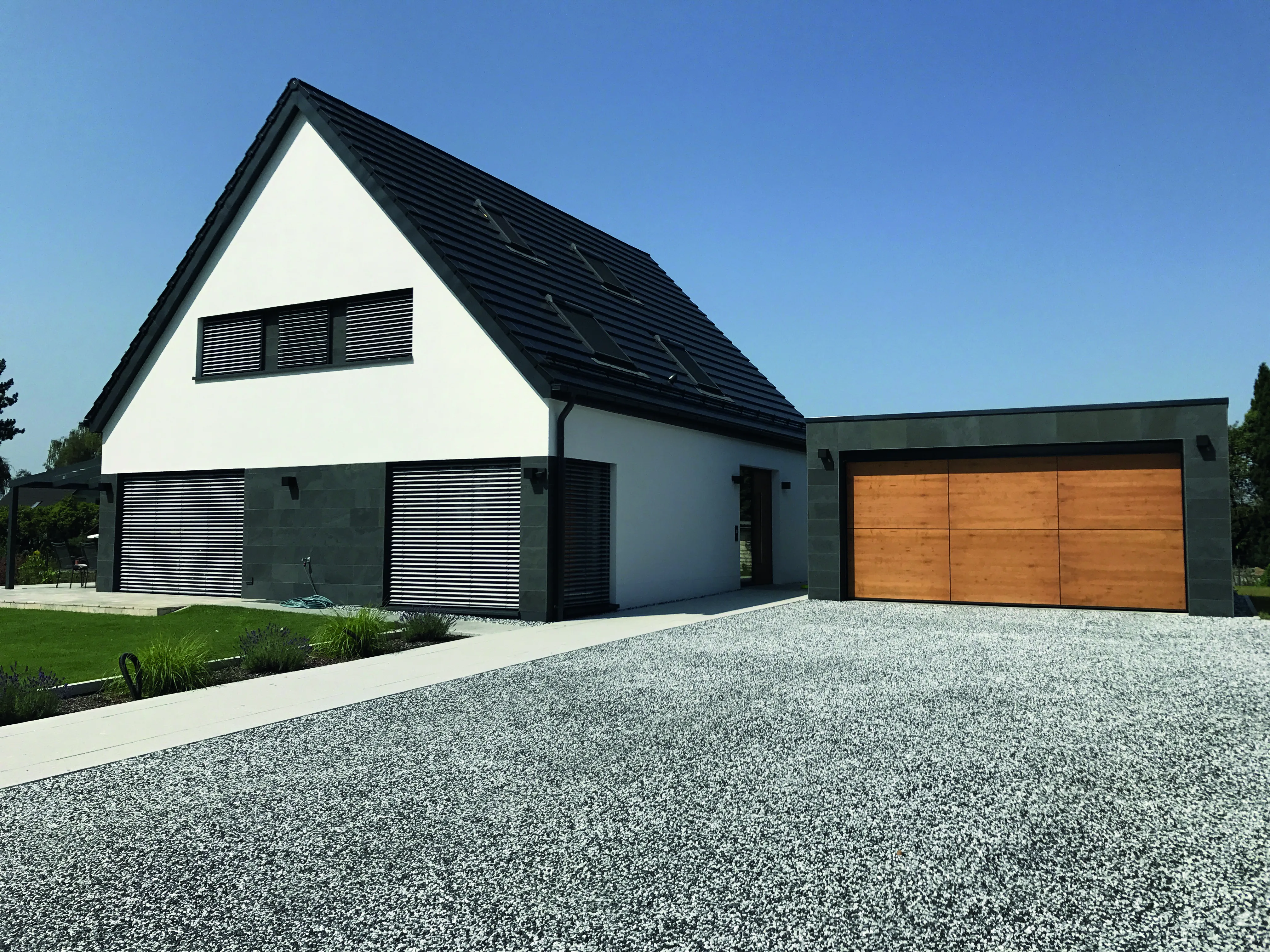 Image of a gravel driveway outside an angular, modern home.