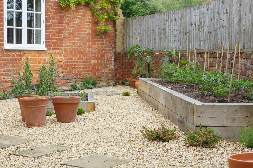Garden sleeper being fixed together using a power tool. Landscaping image