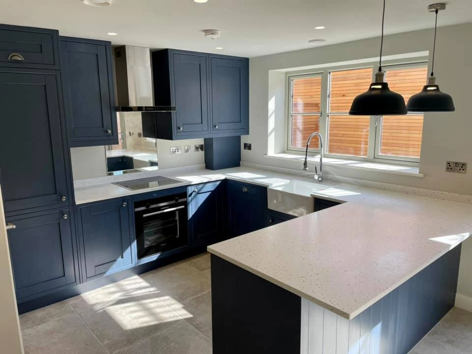 Modern kitchen with blue cupboards and detailings, and an innovative Quooker tap. 