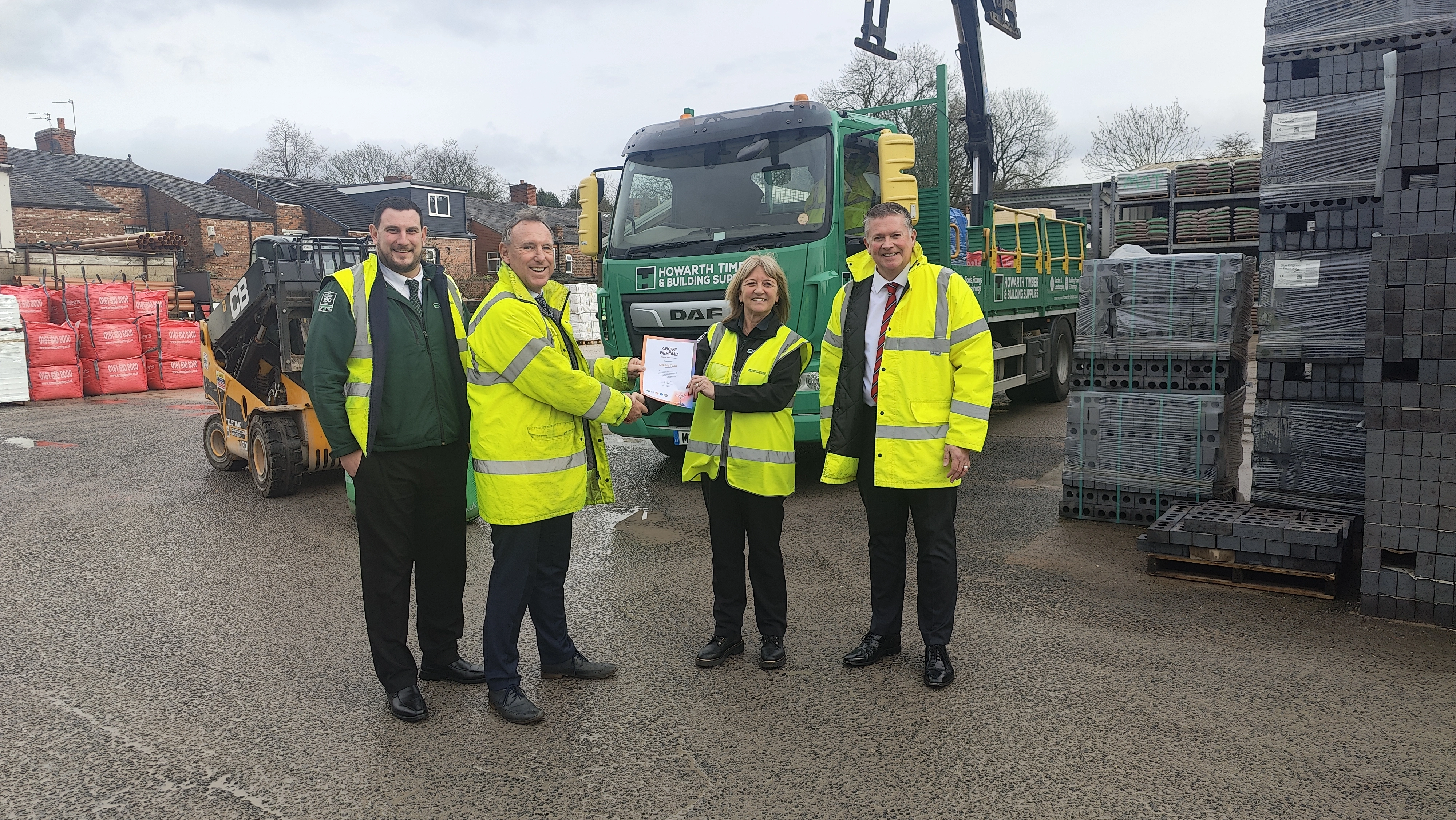 Four people, one of which being Debbie Pollit, our Above and Beyond winner being presented with her award by the CEO, Nick Howarth.