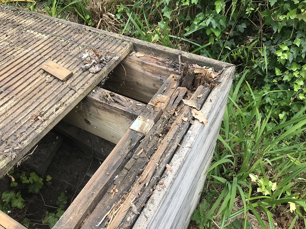 A broken deck, which could've been the result of decay affecting the edges of the wood. 