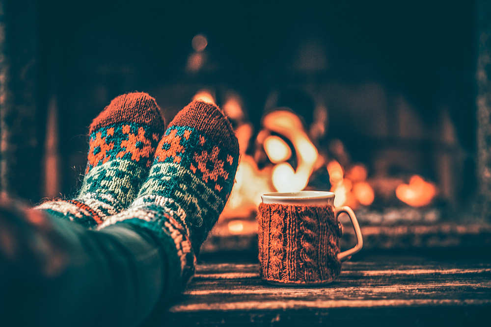 an image of someone with their feet up by the fire
