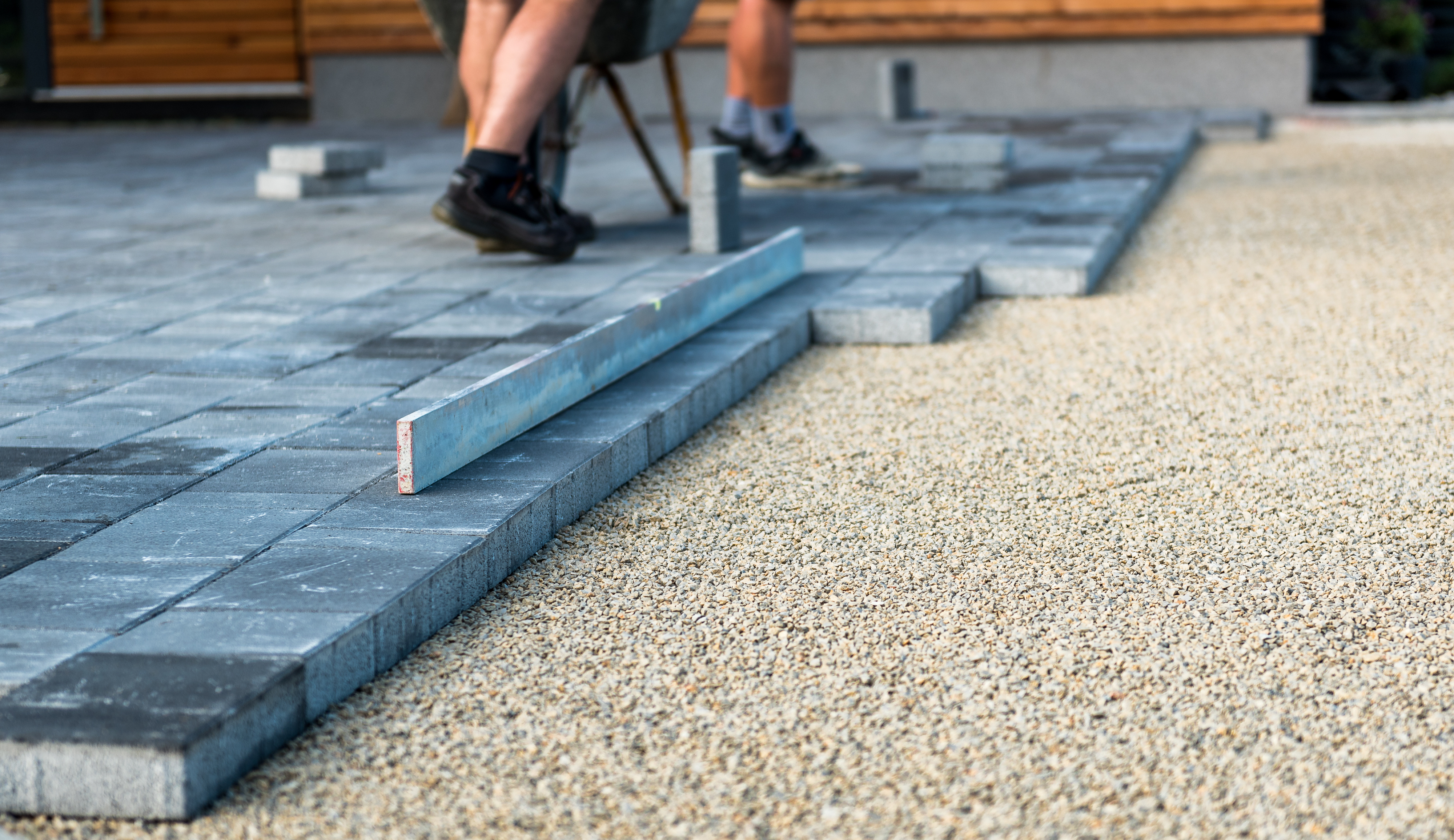 A person measuring out the area for a new patio.