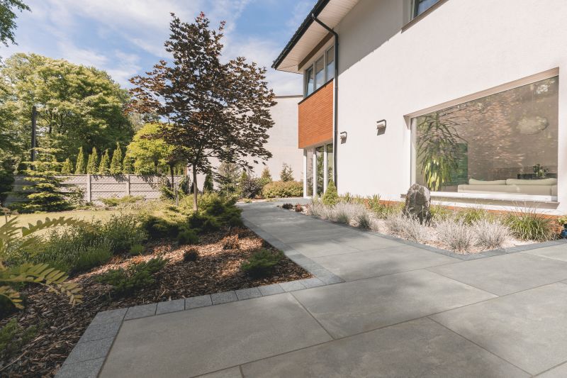 Garden paths ideas for an outside space, with bushes and fencing surrounding it.