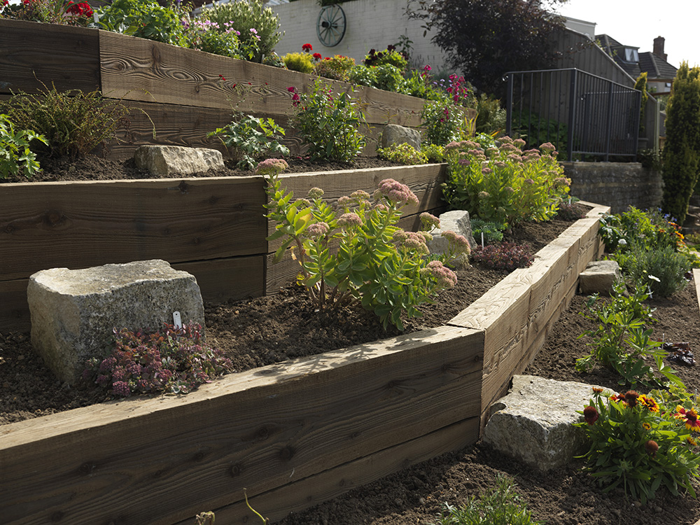 Strengthen your garden's structure and aesthetics with raised garden sleepers, ideal for constructing durable and visually appealing retaining walls, adding depth and character to your outdoor space.