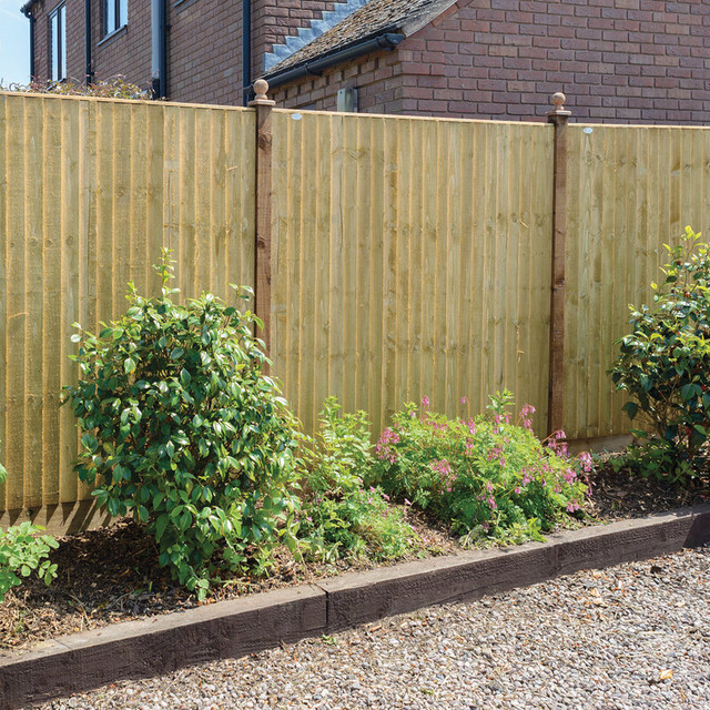 A grey composite fence in a modern, grey-coloured garden. 