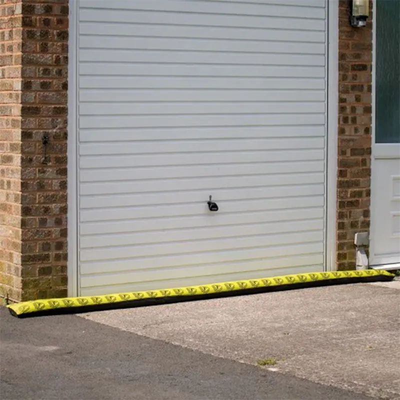 Floodshield absorbent flood barrier being used against a garage door.