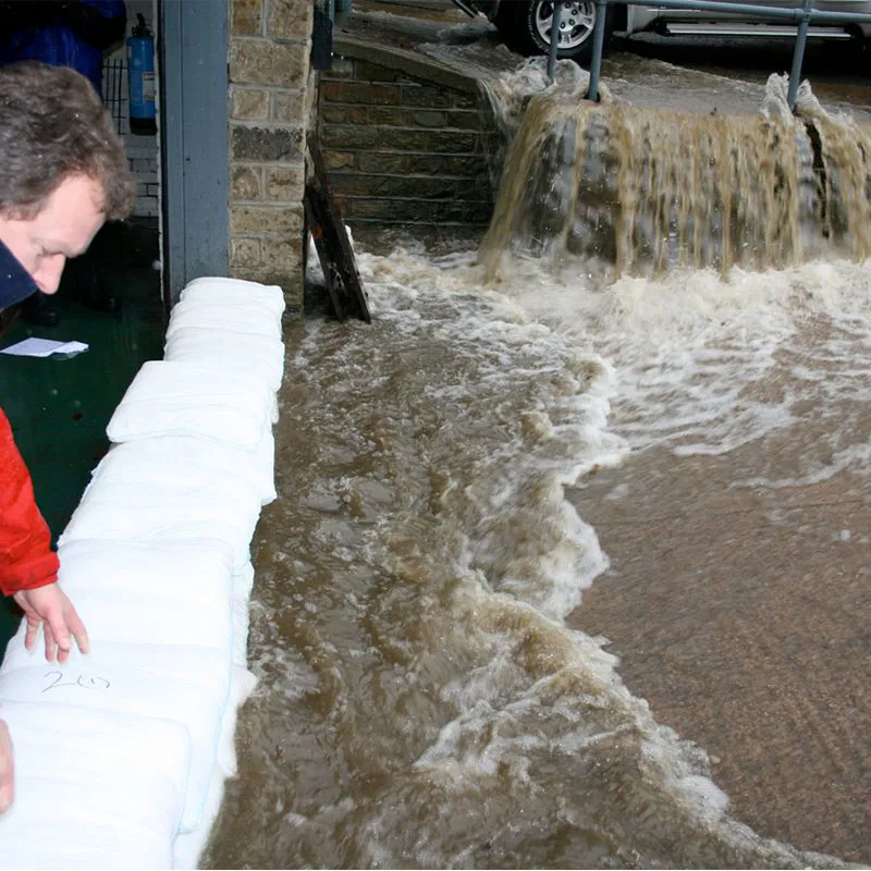 Floodshield product being used to defend a house from water.