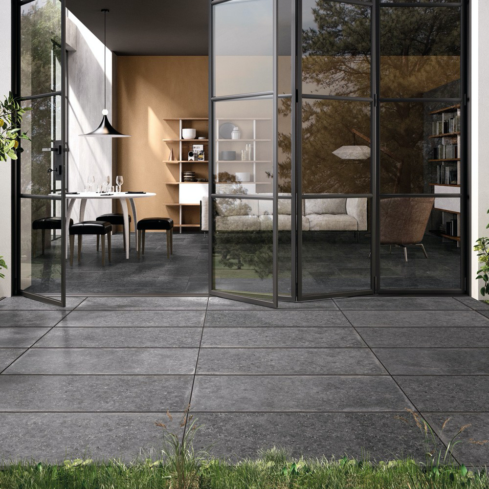 A lifestyle picture of porcelain paving in and outside garden. 