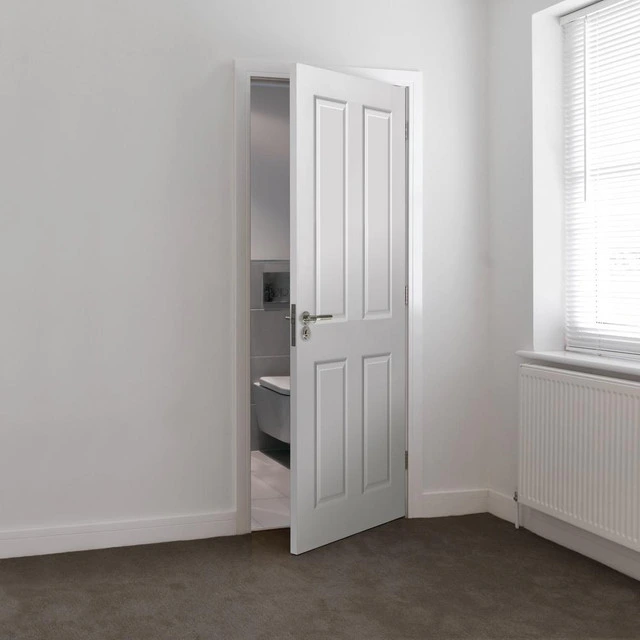 A white internal fire door opening in a white, plain, modern room. A white internal fire door opening in a white, plain, modern room.