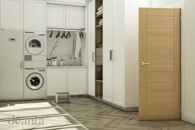 An oak internal fire door opened in a laundry room, with white furnishings and oak flooring. An oak internal fire door opened in a laundry room, with white furnishings and oak flooring.