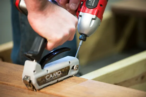 A camo tool being used with decking for easy application.
