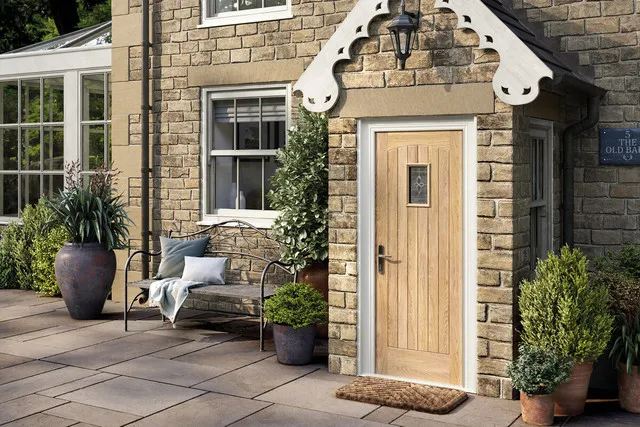 Image of a front door leading into a house, with the door being beige in colour.
