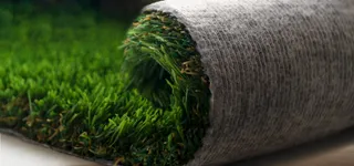 Artificial grass layered so that you could see it before it is laid down.