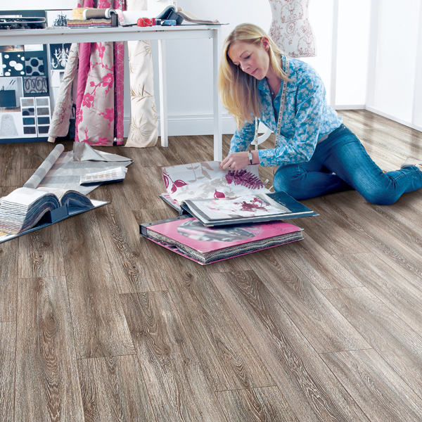 an image of a dark brown laminate flooring in beige room with LEGO on floor
