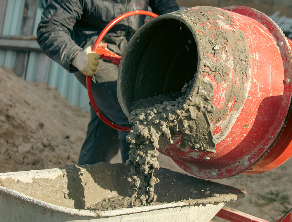 an image of an electric cement mixer and man in hi vis jacket