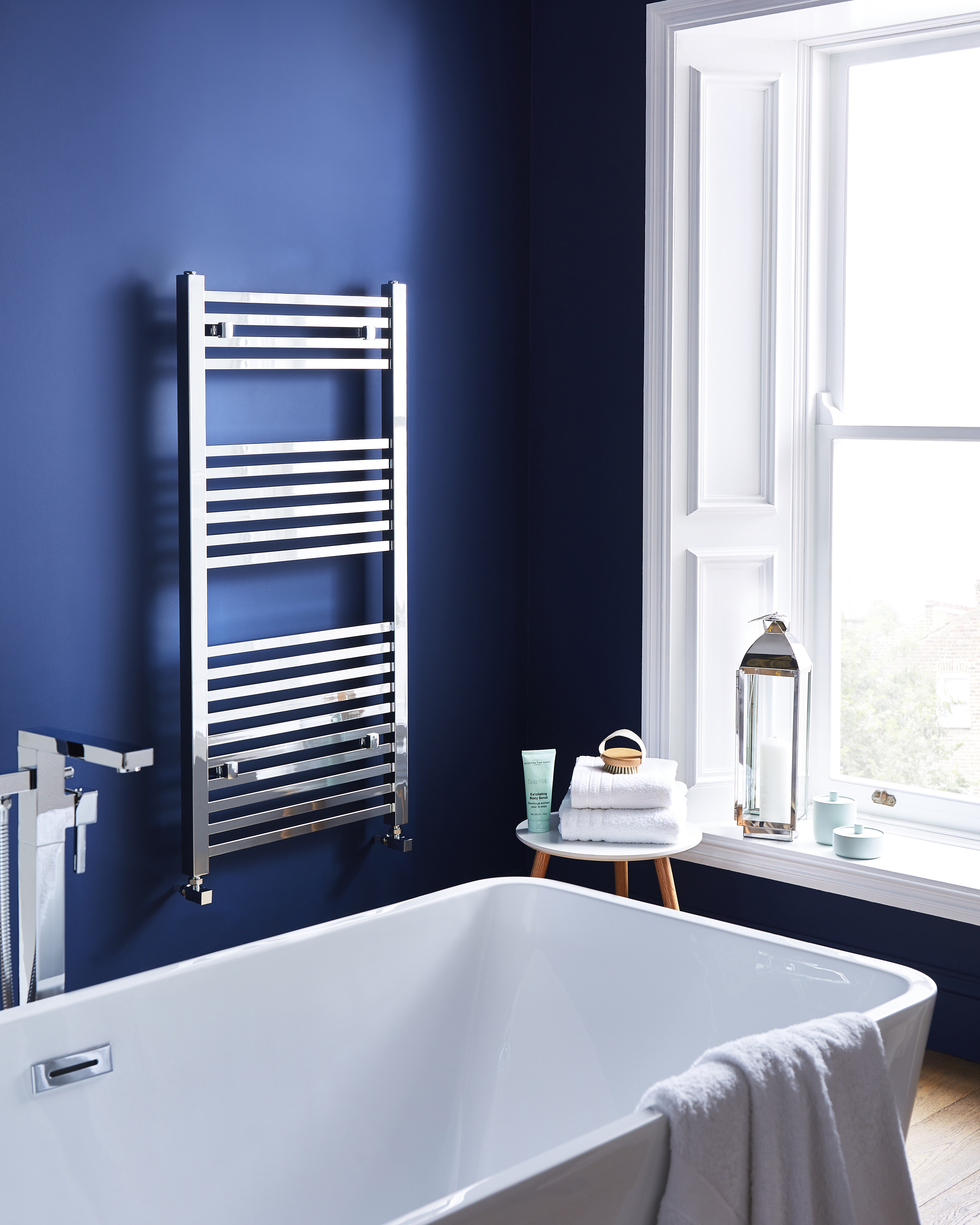 an image of a bathroom and ladder rail with towels on it.  an image of a bathroom and ladder rail with towels on it.