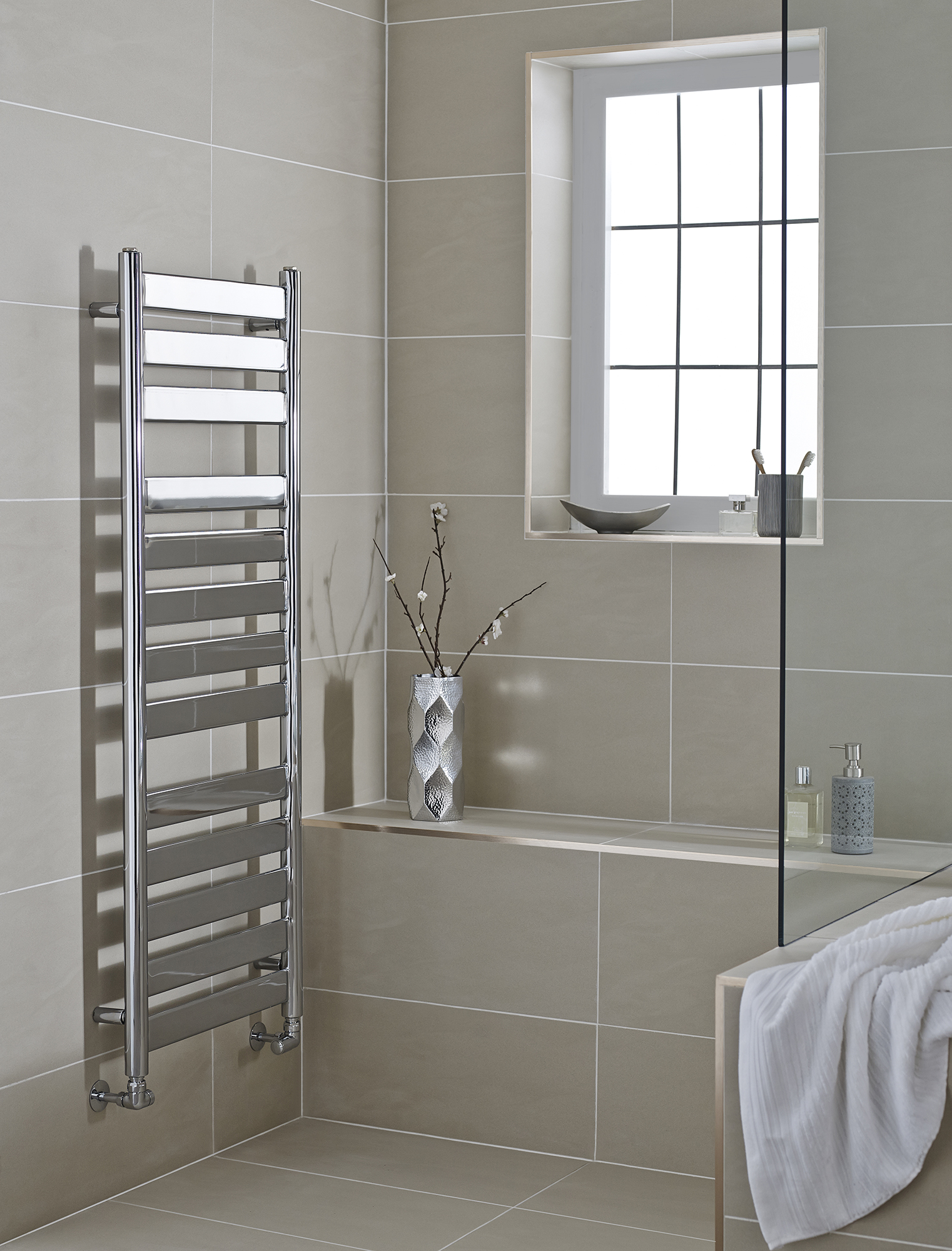 an image of a chrome towel rail in a modern bathroom an image of a chrome towel rail in a modern bathroom