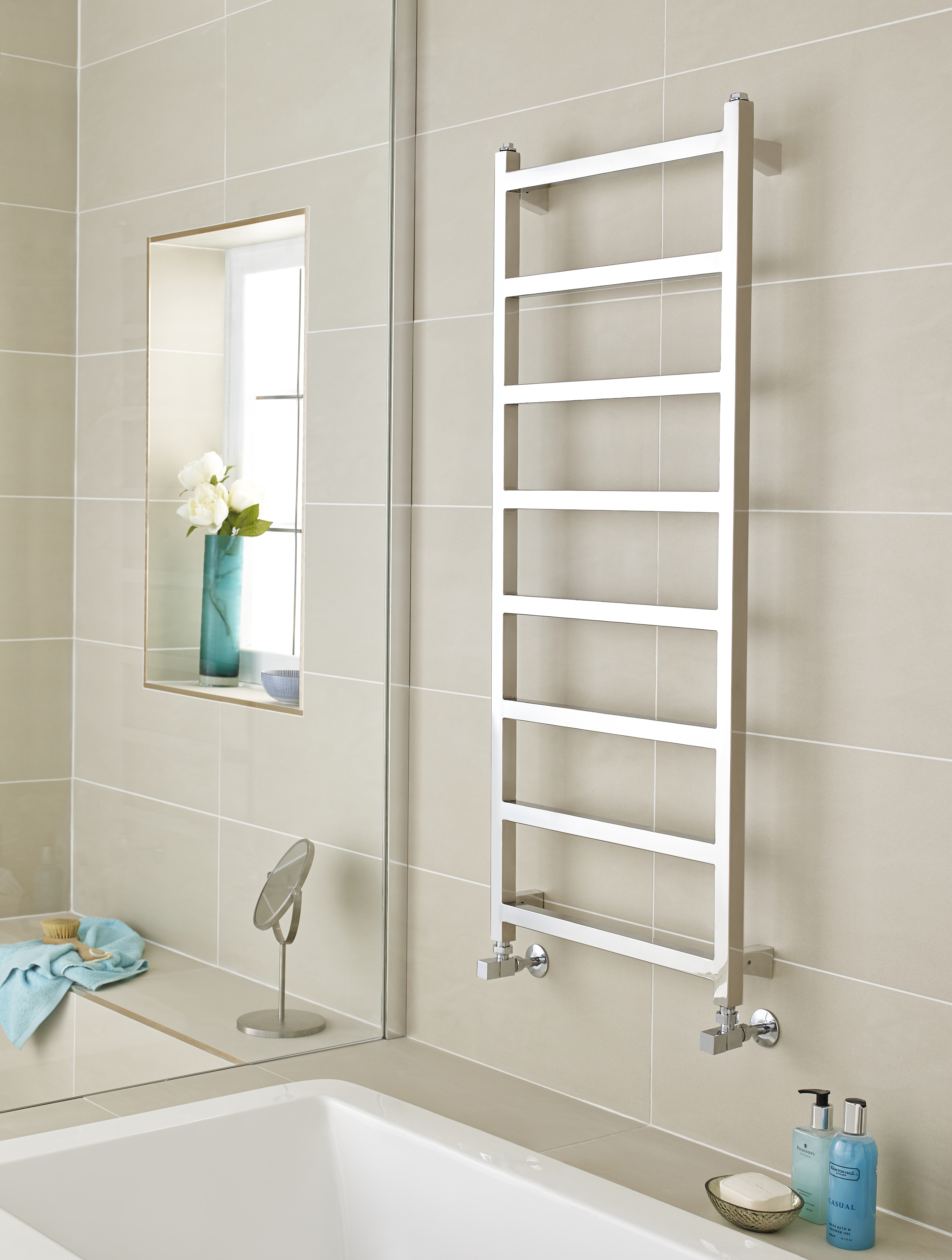 an image of a chrome ladder towel rail in a bathroom. an image of a chrome ladder towel rail in a bathroom.