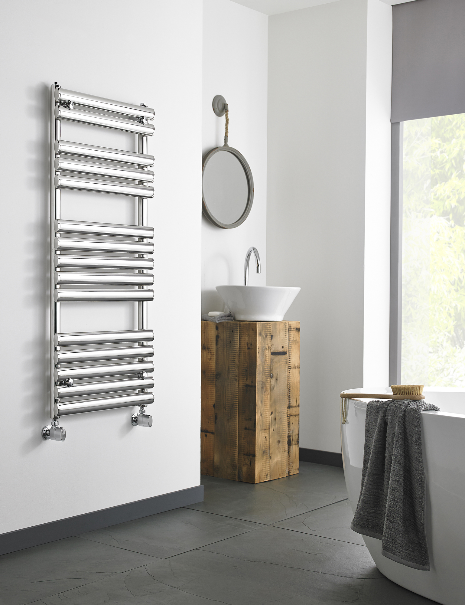 an image of a chrome modern towel rail in a bathroom.  an image of a chrome modern towel rail in a bathroom.