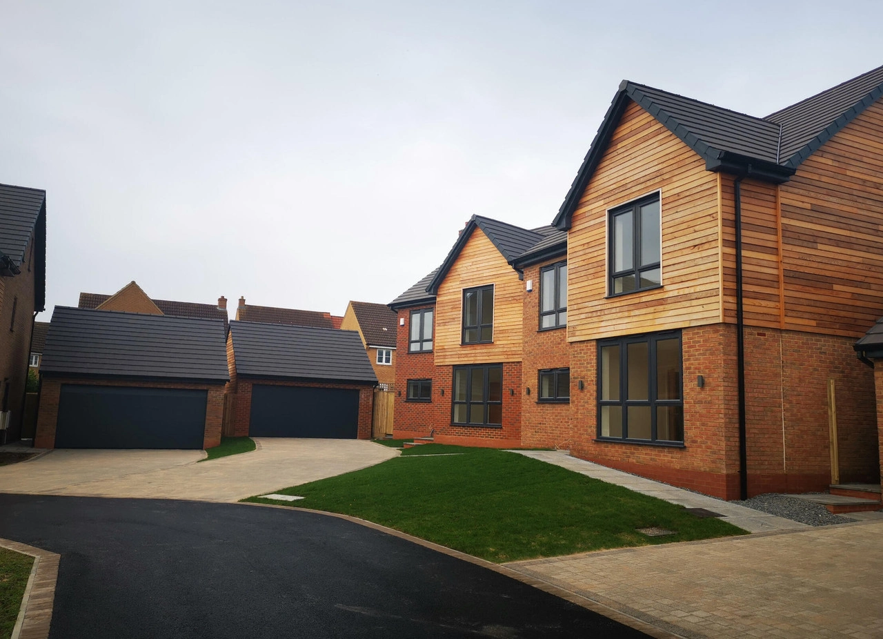 A row of houses in a neighbourhood which have completley made out of timber cladding. 