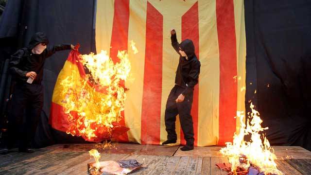 Encapuchados queman la bandera española