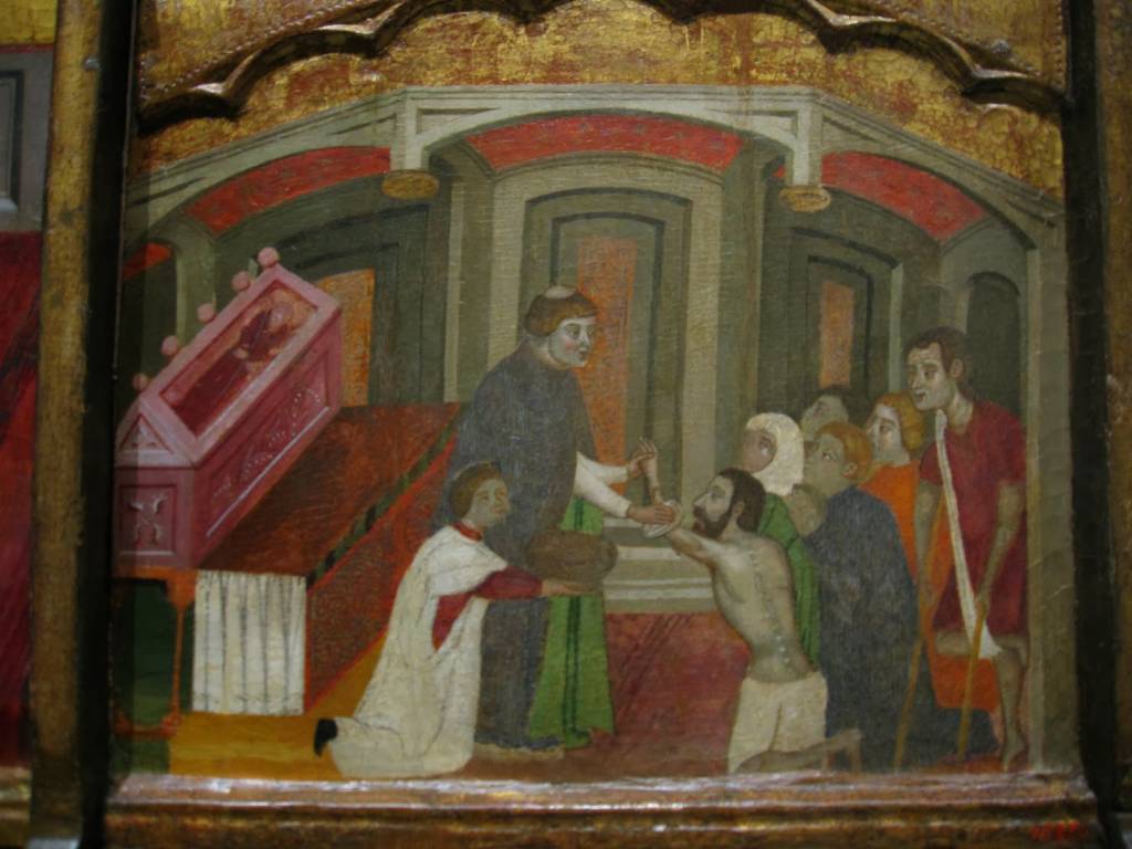 Retablo de San Antonio (fragmento) en el que puede verse un fraile antoniano atendiendo a los enfermos del fuego de San Antonio. MNAC (Barcelona)